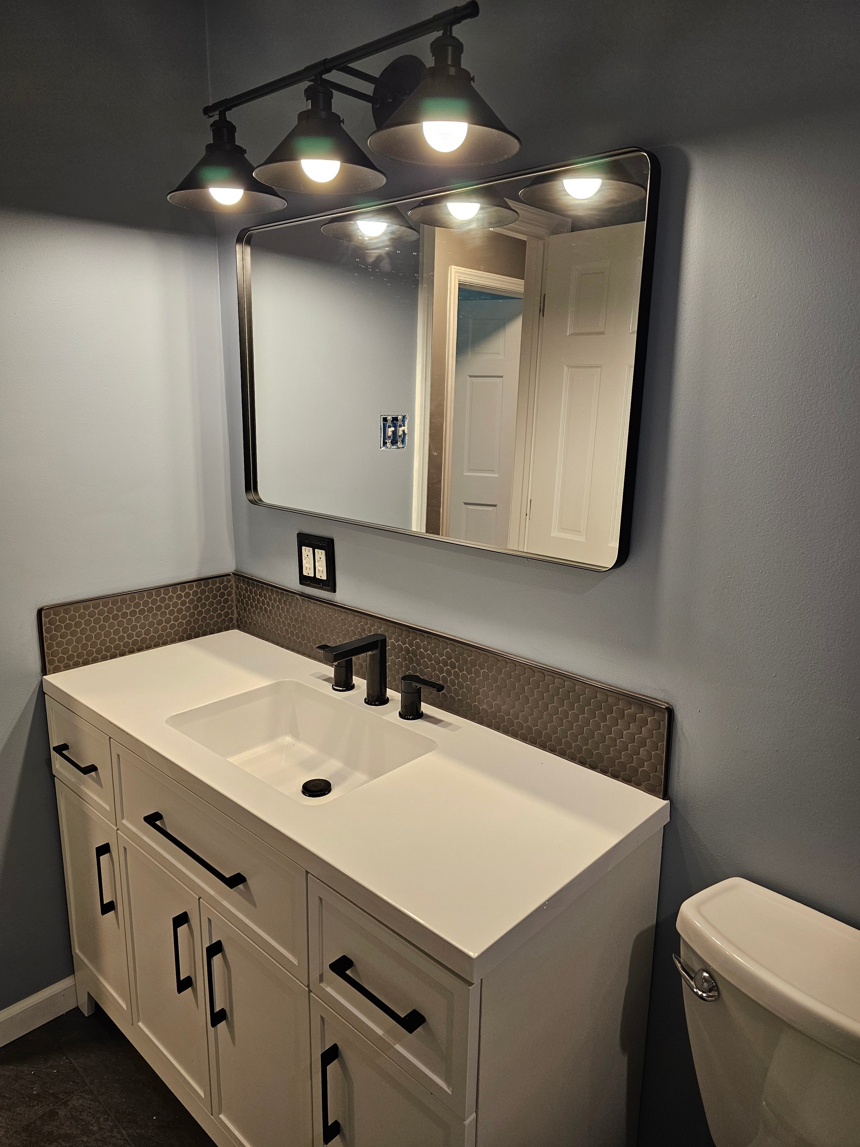 Sink with Dark Faucet and Extended Mirror