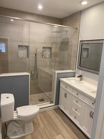 Bathroom with blue grey divider and standing shower